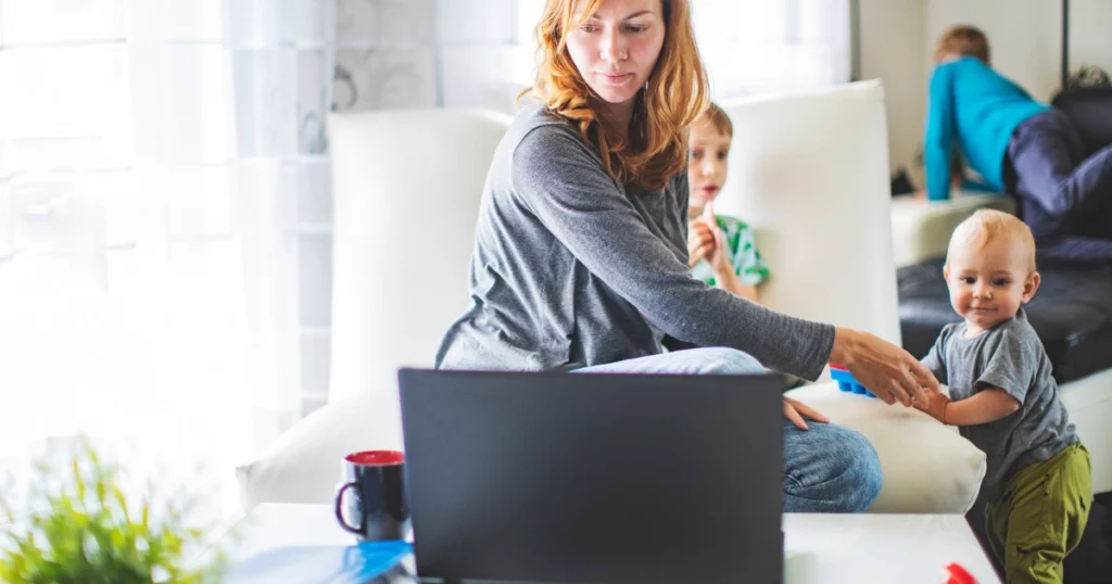 Busy parent balancing homeschool planning with work and young children