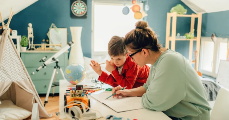 Mother helping child with schoolwork at home learning table