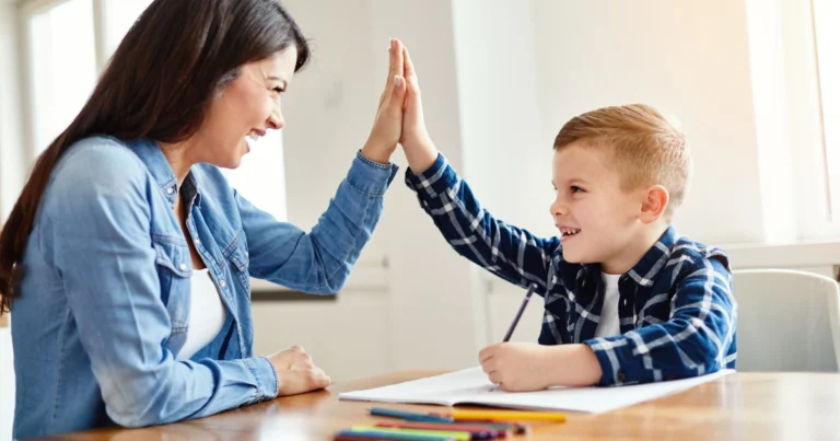 Parent helping child with homeschool lesson and celebrating progress