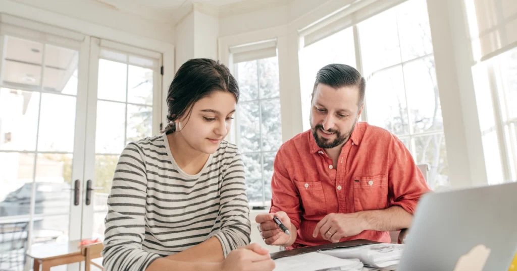 Parent helping child with schoolwork at home