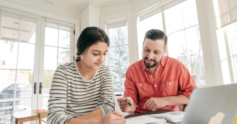 Parent helping child with schoolwork at home