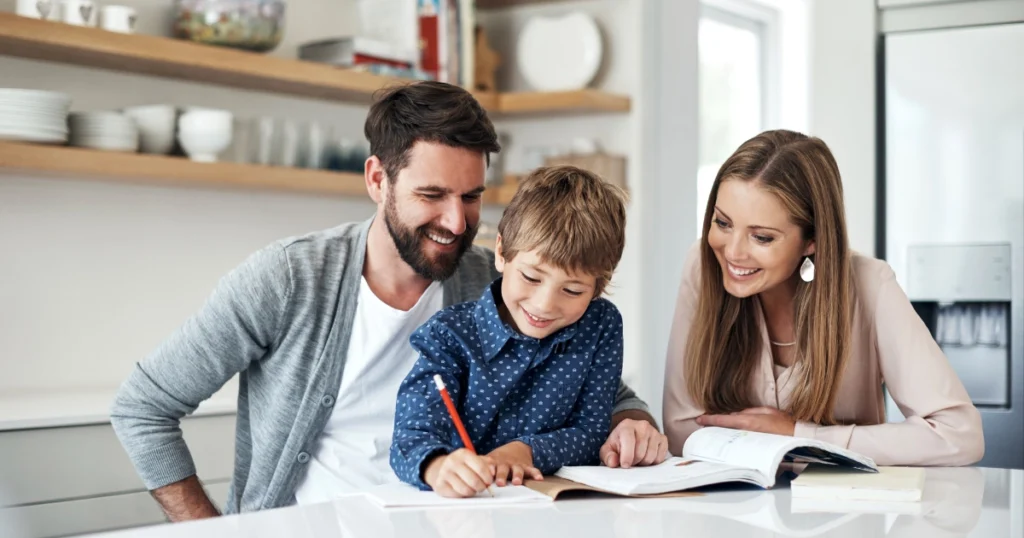 Parents helping their child with schoolwork during a homeschooling lesson at home.