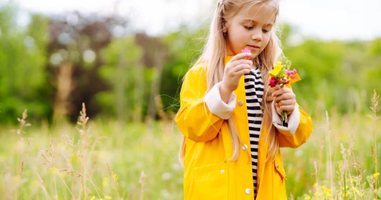 Child exploring flowers outdoors during recovery from school stress
