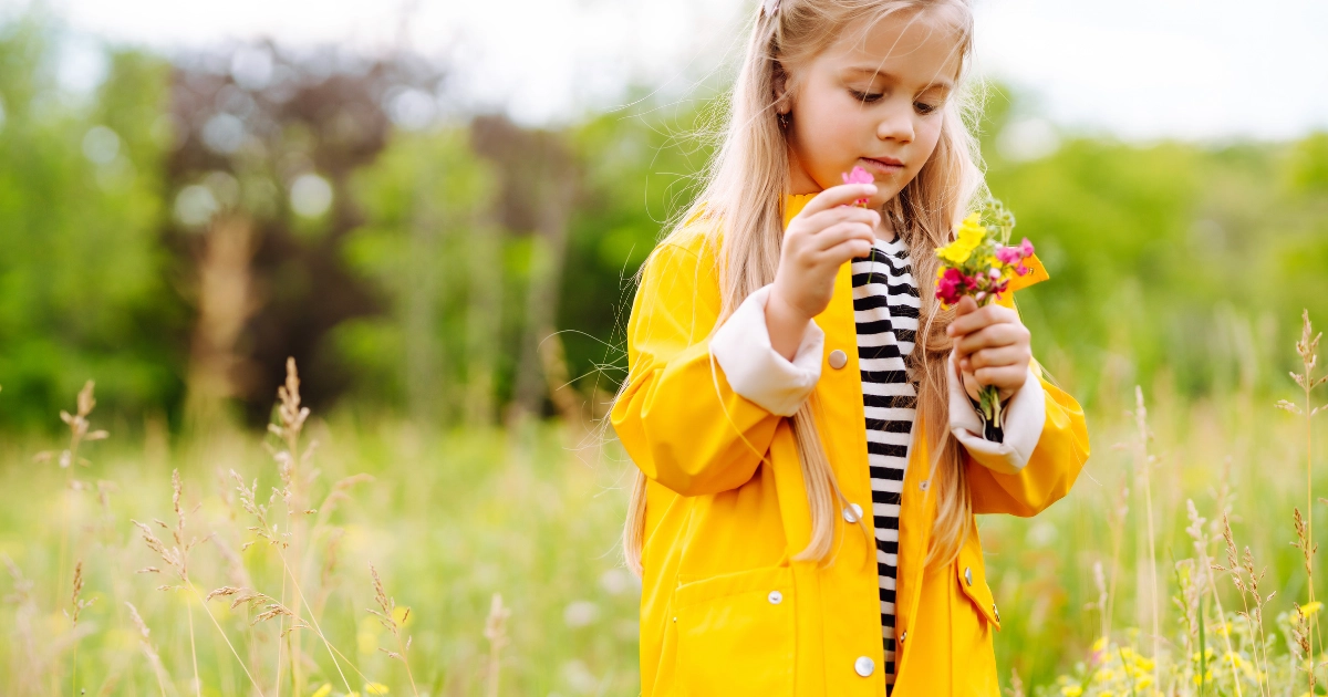 Child exploring flowers outdoors during recovery from school stress