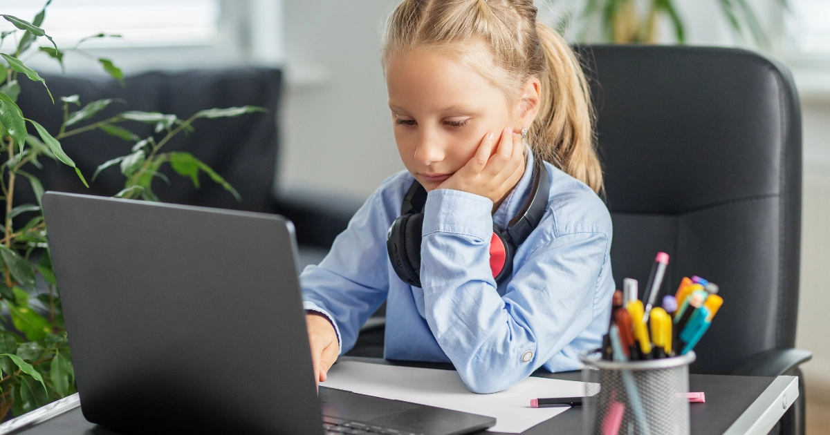 Child learning on a laptop at home during a virtual school lesson