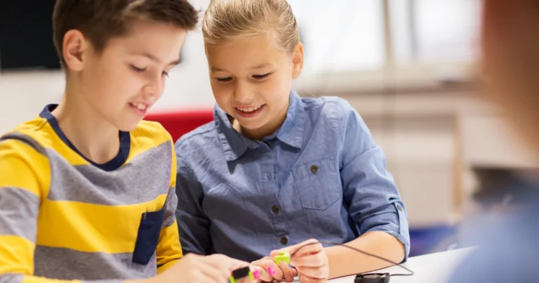 Two children working together on a hands-on activity, showing focused and meaningful social interaction