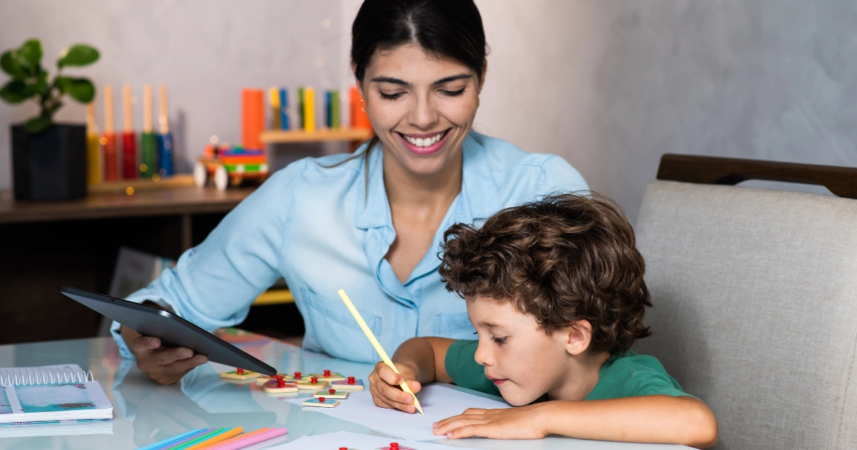 Parent helping young child with a homeschool lesson at the kitchen table using a structured curriculum.